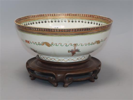 A late 18th century Chinese export polychrome bowl, decorated with a band of ribbon and flowers in baskets, with hardwood stand diamete